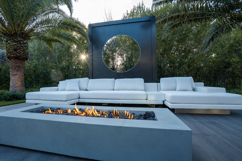 Pool deck with fire table at dusk